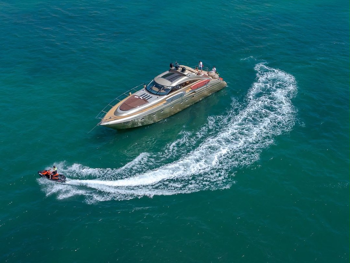 Luxury motor yacht and jet ski on the turquoise water of the Algarve coast near Albufeira, part of Atlantic Golf Breaks' water and coastal experiences